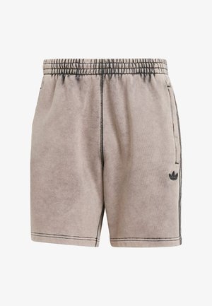 Shorts de sport beige clair avec une texture douce, une taille élastique, des poches latérales et des accents noirs. Présente un logo subtil sur le côté gauche.