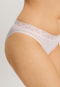 Tanga z lehkého šedého bavlněného materiálu s krajkovým lemem, hladkou texturou a květinovým krajkovým pásem podél pasu.