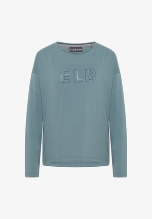 Svijetloplavljena košulja dugih rukava od mekog materijala. Ima ispečene slova "ELB", okrugli izrez i ležeran kroj.