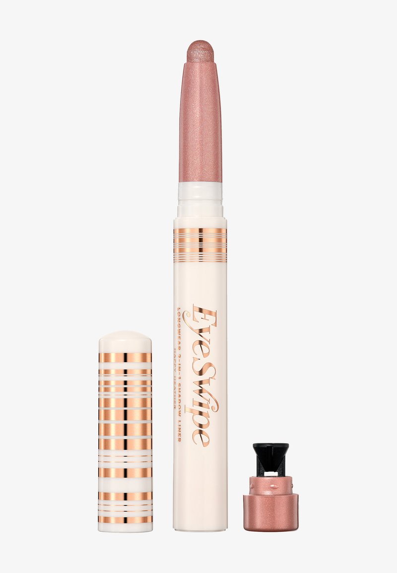 Fard à paupières en stick crémeux avec une pointe métallique rose, un corps blanc et des accents rayés dorés. Comprend un petit capuchon noir pour la protection.