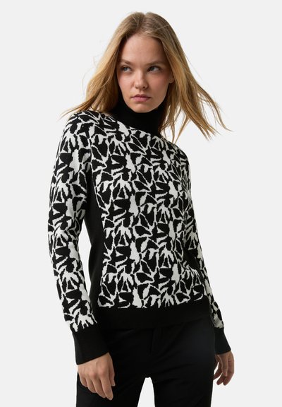 Πλεκτό πουλόβερ με μοτίβο φύλλων σε ασπρόμαυρο, μαύρο rib πλεκτό ζιβάγκο και μακριά μανίκια με μαύρες πλευρικές λωρίδες.