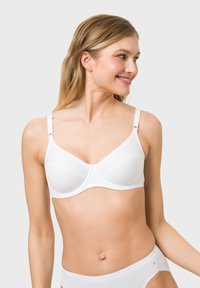 White bra with smooth fabric, underwire support, and adjustable straps. Features a scalloped trim and lightly contoured cups.
