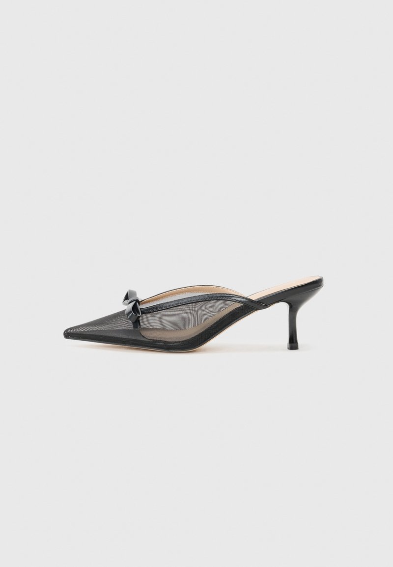 Zwarte mesh slingback schoen met spitse neus en een kleine hak. Heeft een decoratieve strik op de bovenkant en een gladde zool. Lichtgewicht ontwerp.