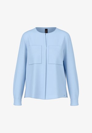Light blue long-sleeve shirt with round neckline, two chest pockets, and hidden front closure, displayed on white background.