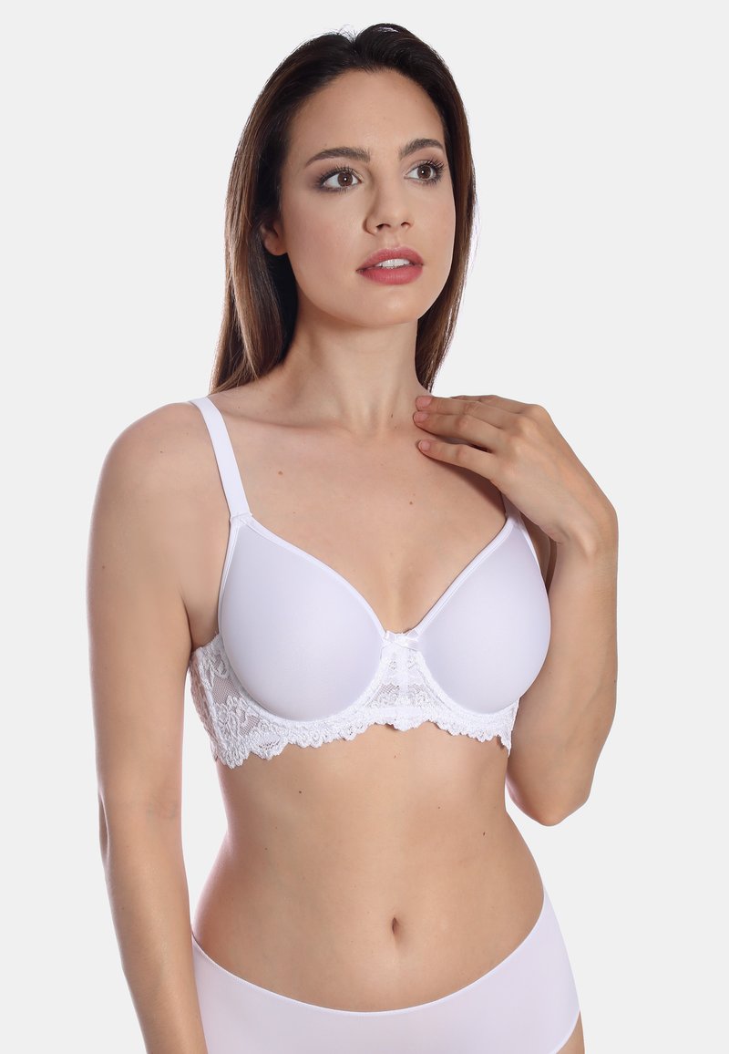 White bra with smooth padded cups, lace detailing along the band, adjustable straps, and a small bow at the center.