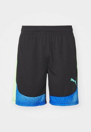 Shorts noirs avec un panneau latéral vert et un ourlet à motifs en dégradé bleu. Dotés d'une taille élastique et d'un petit logo Puma en vert.
