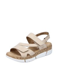 Beige sandaler med justerbara remmar, vadderad fotbädd och texturerad korkliknande sula. Designen har öppen tå och stöd för bakre häl.