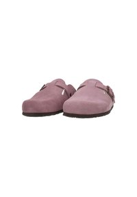 Pink suede clogs with a rounded toe, two decorative buckles, and cut-out accents along the sides; thick black rubber soles.