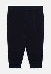 Koton hlače za jogger, temno mornarsko modre, zožana silhueta, elastičen pas, zategnjeni gležnji, gladka tekstura, minimalističen dizajn, brez žepov.