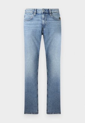 Jeans a gamba dritta blu chiaro esposti su uno sfondo bianco semplice, con chiusura a bottone e leggeri sbiadimenti sulle gambe.
