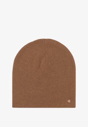 Brown knitted beanie, soft texture, rounded top, and a small metal logo accent on the side. Simple design with no patterns.