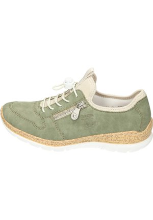 Green suede sneaker with cream accents, featuring a side zipper and elastic laces, mounted on a textured cork and white rubber sole.