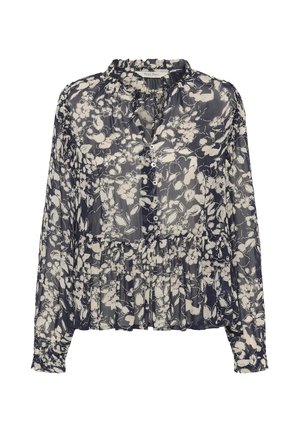 Blouse bleu marine transparent avec motif floral blanc, manches longues, devant boutonné, col à volants et taille froncée.