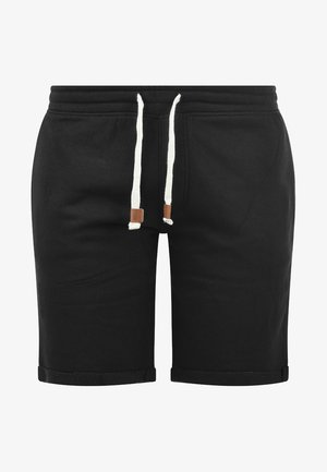 Črne bombažne kratke hlače za srajce z elastičnim pasom, belimi vrvmi in zvitimi robovi. Imajo našit logotip na pasu.