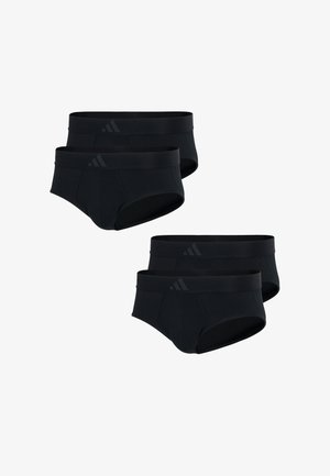 Sorte svømmebukser med et ensfarvet design, elastisk talje og en tætsiddende pasform, vist på en model med en neutral baggrund.