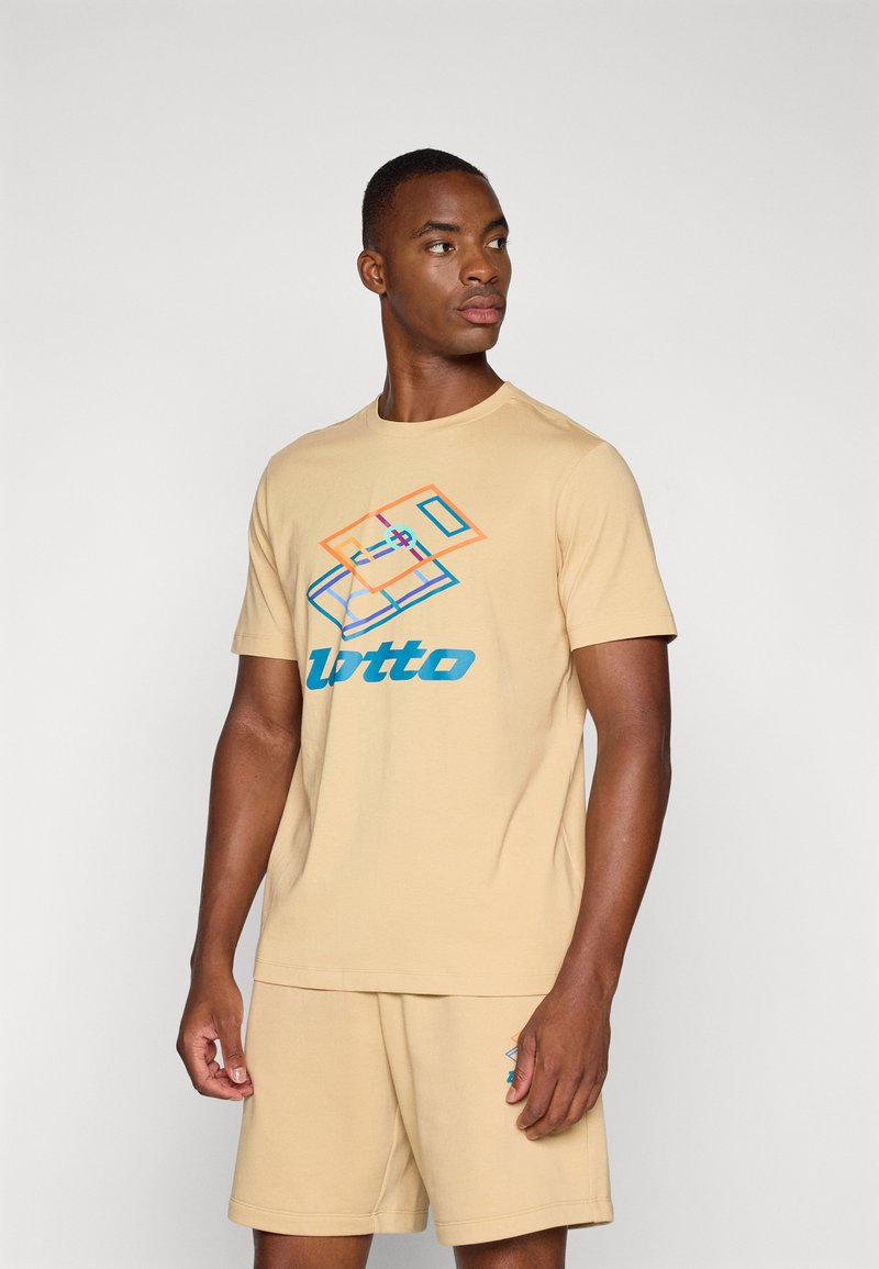 Beige cotton t-shirt featuring blue and orange geometric design and "lotto" text. Model wearing matching beige shorts.