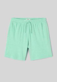 Shorts vert menthe avec taille élastique, poches avant et cordon, en tissu doux.