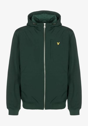 Mörkgrön huvjacka i slätt tyg, med dragkedja fram, elastiska ärmslut, två sidofickor och en liten gul logotyp på bröstet.