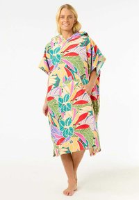 Poncho serviette coloré avec des motifs floraux vibrants en vert, rouge, rose et jaune. Comprend une capuche et des poches. Fabriqué en tissu doux.