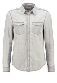 Chemise grise à manches longues en tissu denim, dotée d'un col boutonné, de deux poches poitrine et de détails de coutures contrastantes.