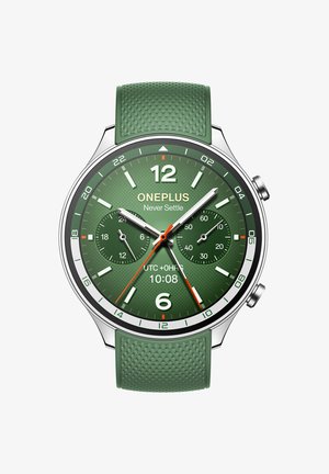 Green silicone strap watch with a textured surface, metallic silver case, green dial, white and red accents, and chronograph subdials.
