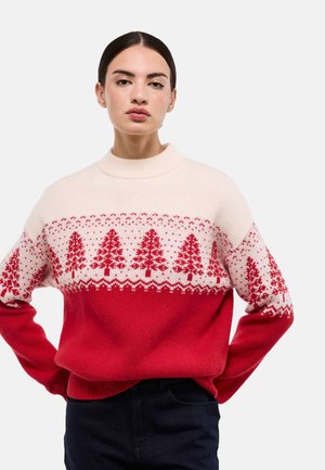 Pull tricoté rouge et crème avec col rond, motifs de flocons de neige et d'arbres en rouge, section inférieure unie rouge et poignets côtelés.
