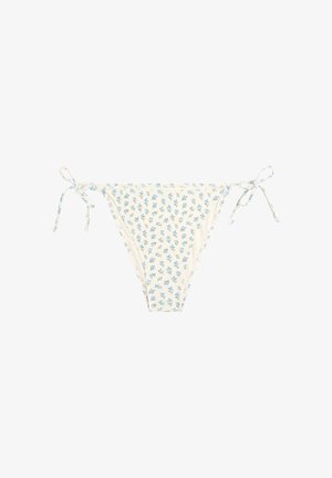 Culotte de bikini crème avec motif floral bleu et liens latéraux ajustables, posée à plat sur un fond blanc.