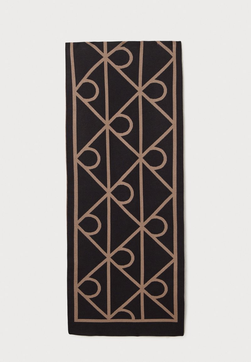 Tissu rectangulaire noir avec un motif géométrique beige répétitif de triangles et de demi-cercles formant une grille.