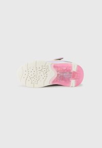Shoe sole with a beige rubber base featuring star patterns, pink accents, and a transparent section, designed for traction and cushioning.