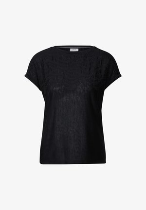 T-shirt noir en tissu doux, avec un motif texturé sur le haut. Manches courtes, coupe décontractée et col rond.