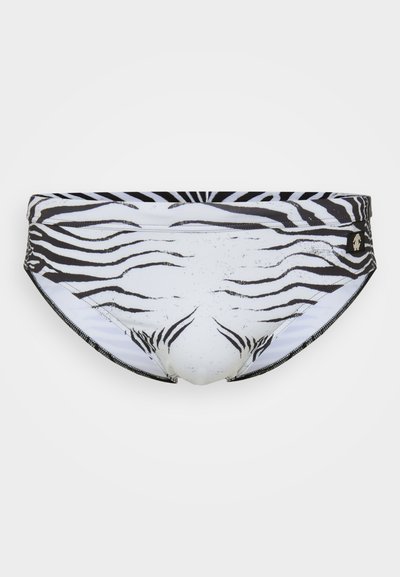 Simrödsbyxor i zebramönster med svart och vit design, slät tyg, låg midja och elastiskt midjeband för extra komfort.