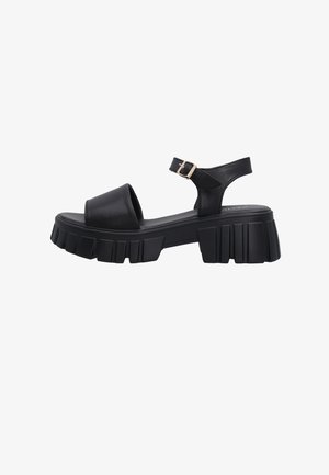 Sort læder chunky platform sandal med bred frontrem, ankelrem med guldlås og tekstureret rullesål.