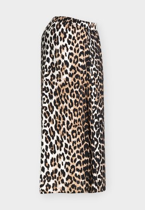 Jupe midi à motif léopard avec taille élastique, présentant des taches noires, brunes et blanches sur un tissu fluide.