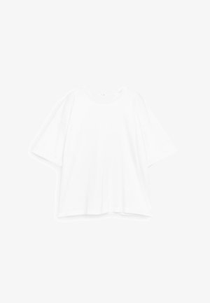 T-shirt blanc surdimensionné à manches courtes avec encolure ronde, présenté à plat sur un fond blanc.