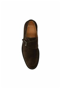Brown suede slip-on shoe with a rounded toe, featuring a decorative buckle and smooth leather lining, set against a white background.