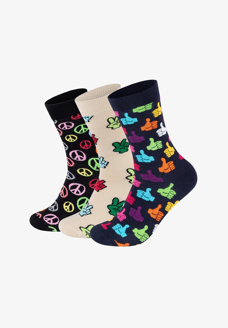 Tre par strømper med iøjnefaldende mønstre: sorte med fredssymbole, beige med bladmotiver og marineblå med farverige tommelopadser.