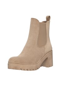 Stivale alla caviglia in suede beige con punta arrotondata, pannelli laterali elasticizzati e tacco chunky. Suola in gomma texturizzata con battistrada per una buona aderenza.