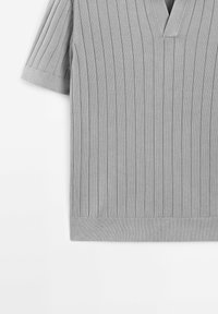 Gray knitted short-sleeve top with a V-neck, featuring vertical ribbed texture and a straight hem. Simple, contemporary design.
