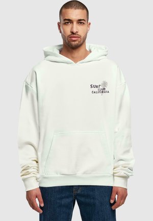 Cream-colored hoodie made of soft cotton, featuring a front pocket, ribbed cuffs, and "SURF CLUB CALIFORNIA" graphic with palm tree design.