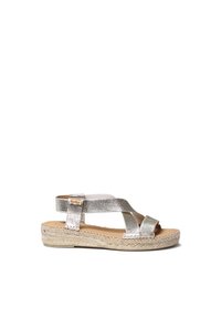 Metallic silver espadrille sandal featuring crisscross straps, a back heel strap, and a woven jute sole. Smooth texture and flat design.