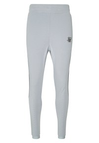 Svetle šedé sportovní kalhoty s texturovaným síťovaným vzorem, černými bočními pruhy a malým černým logem na horní levé straně.