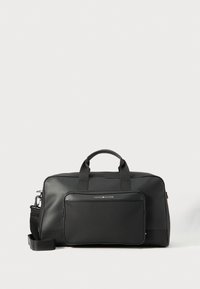 Black duffle bag made of smooth synthetic material. Features dual handles and a front zip pocket, with a detachable shoulder strap.