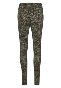 Leggings de couleur vert olive avec un motif texturé de points noirs irréguliers, dotés d'une taille élastique et d'un design ajusté.