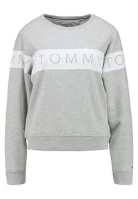 Szara bluza z mieszanki bawełny, z białym paskiem z wypukłym napisem "TOMMY". Okrągły dekolt i ściągacze na rękawach. Minimalistyczny design.