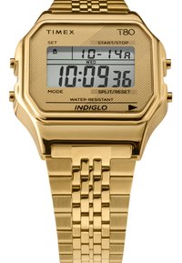 Digitalt ur i guldfarvet tone med oktagonet urkasse, mønstret LCD-skærm og rustfrit stållænke. Har Indiglo-bagbelysning og vandmodstand.