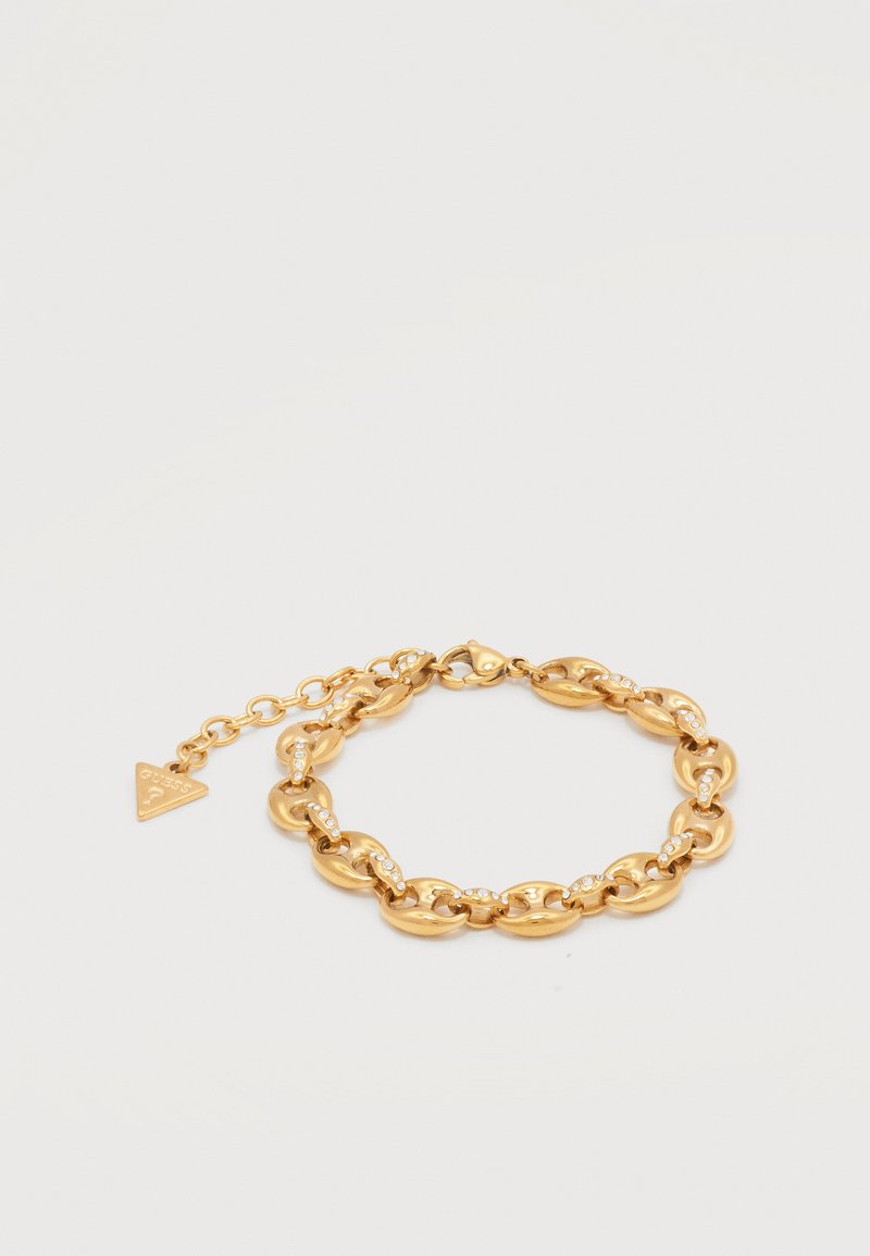 Χρυσό βραχιόλι με αλυσίδα από οβάλ κρίκους, κάθε κρίκος διακοσμημένος με μικρά κρύσταλλα, με ρυθμιζόμενο κούμπωμα και τριγωνικό διακοσμητικό ταμπελάκι.