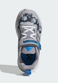 Gray and black athletic shoe with a textured upper, blue accents, velcro strap, and Minecraft-themed inner lining. Rounded sole design.