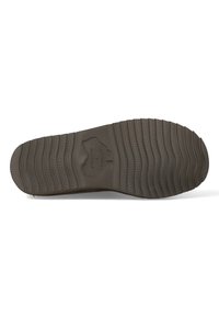 Bruine textuur rubberen zool met een geprofileerd loopvlak voor grip, met een logo in het midden. De rand is iets verhoogd en gebogen.