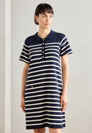 Navy and white striped dress with a polo collar, short sleeves, and five-button placket; features two front pockets with gold accents.