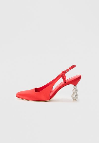 Red satin slingback shoe with a pointed toe and cut-out design. Features a sparkly, rounded heel and an adjustable ankle strap.